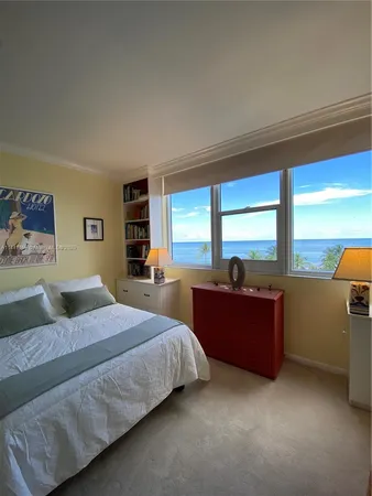 a bedroom with a large bed and a large window