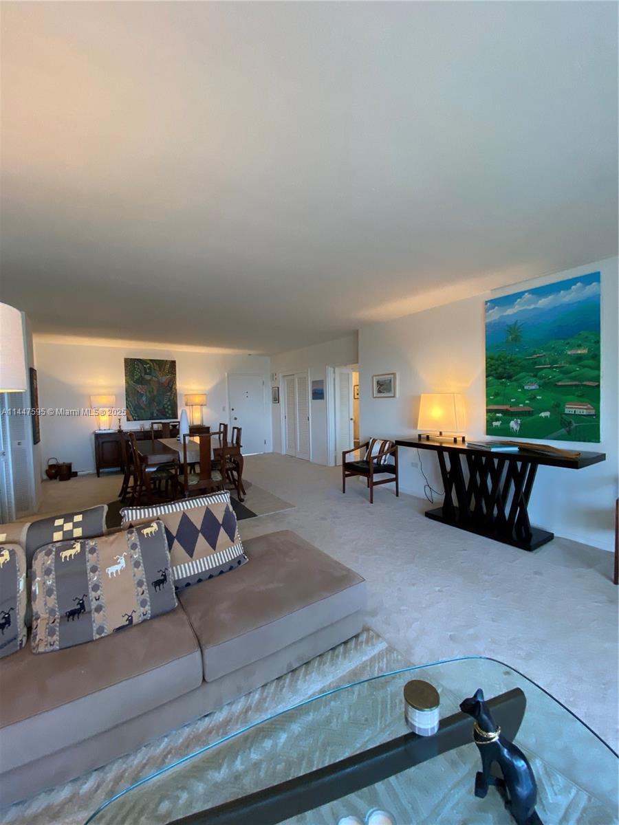 200 Ocean Ln Drive, Unit 706 Key Biscayne, FL 33149 - Photo 22 of 28 a living room with furniture flat screen tv and a large window