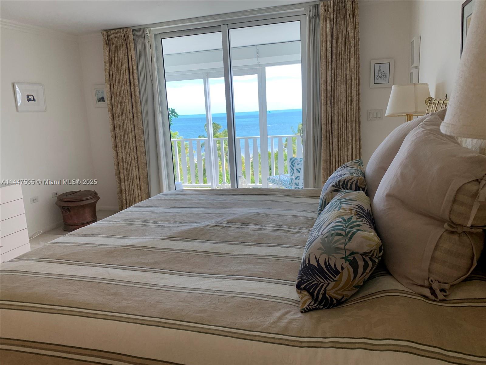 200 Ocean Ln Drive, Unit 706 Key Biscayne, FL 33149 - Photo 3 of 28 a bed sitting in a bedroom next to a window