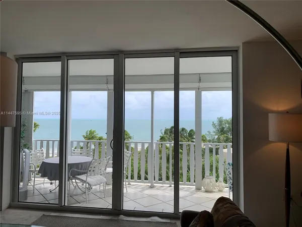 a view of a glass door and porch with a floor to ceiling window