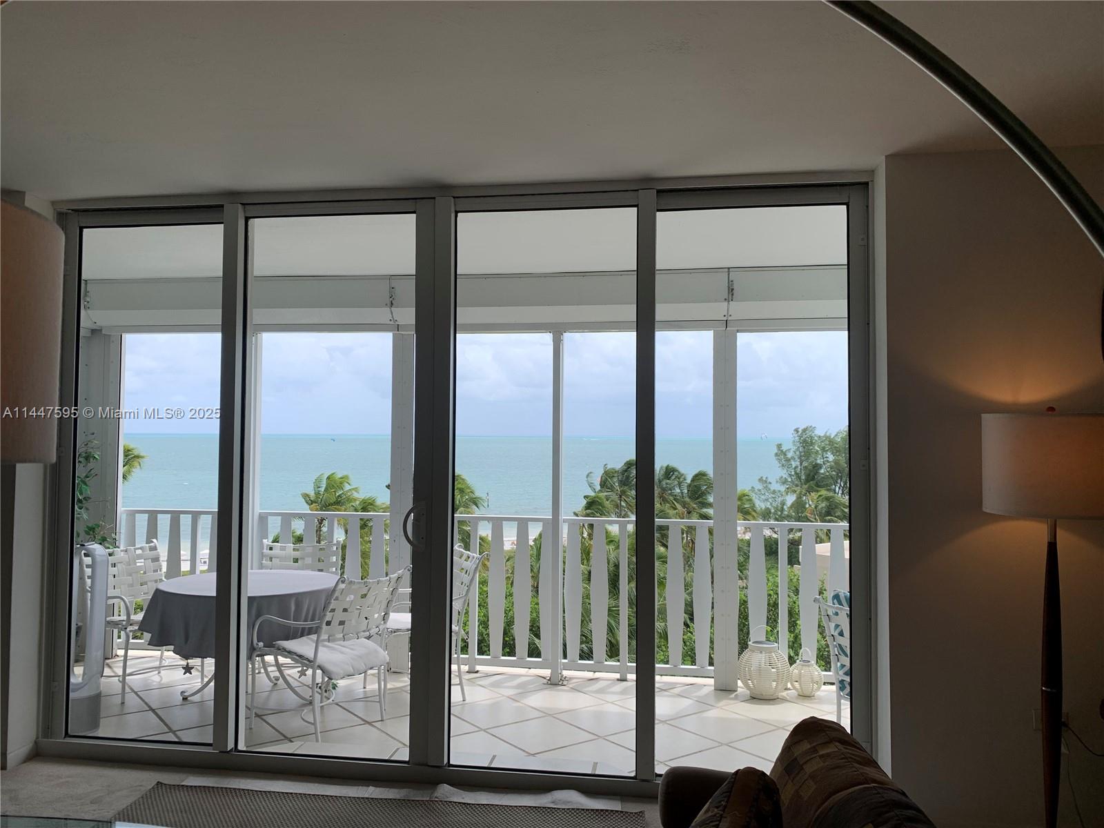 200 Ocean Ln Drive, Unit 706 Key Biscayne, FL 33149 - Photo 6 of 28 a view of a glass door and porch with a floor to ceiling window