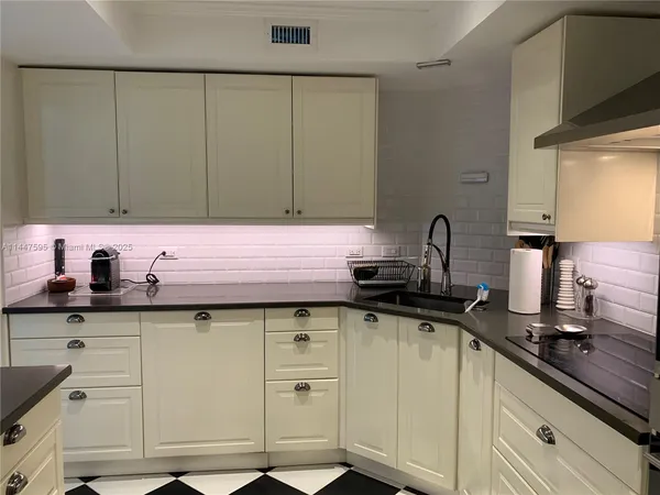 a kitchen with a sink and cabinets