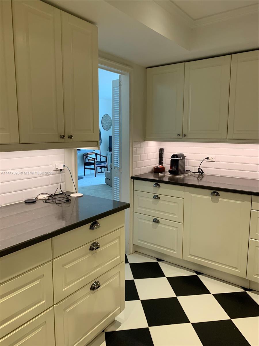 200 Ocean Ln Drive, Unit 706 Key Biscayne, FL 33149 - Photo 9 of 28 a kitchen with a sink window and cabinets