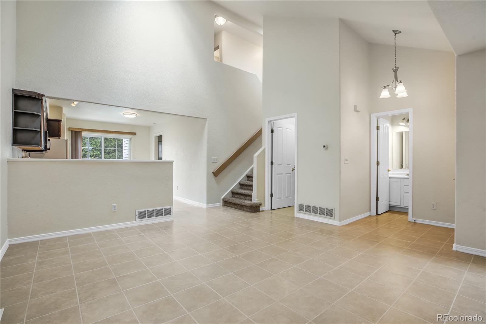 11690 West 46th Avenue Wheat Ridge, CO 80033 - Photo 7 of 33 a view of an empty room with a fireplace and a window