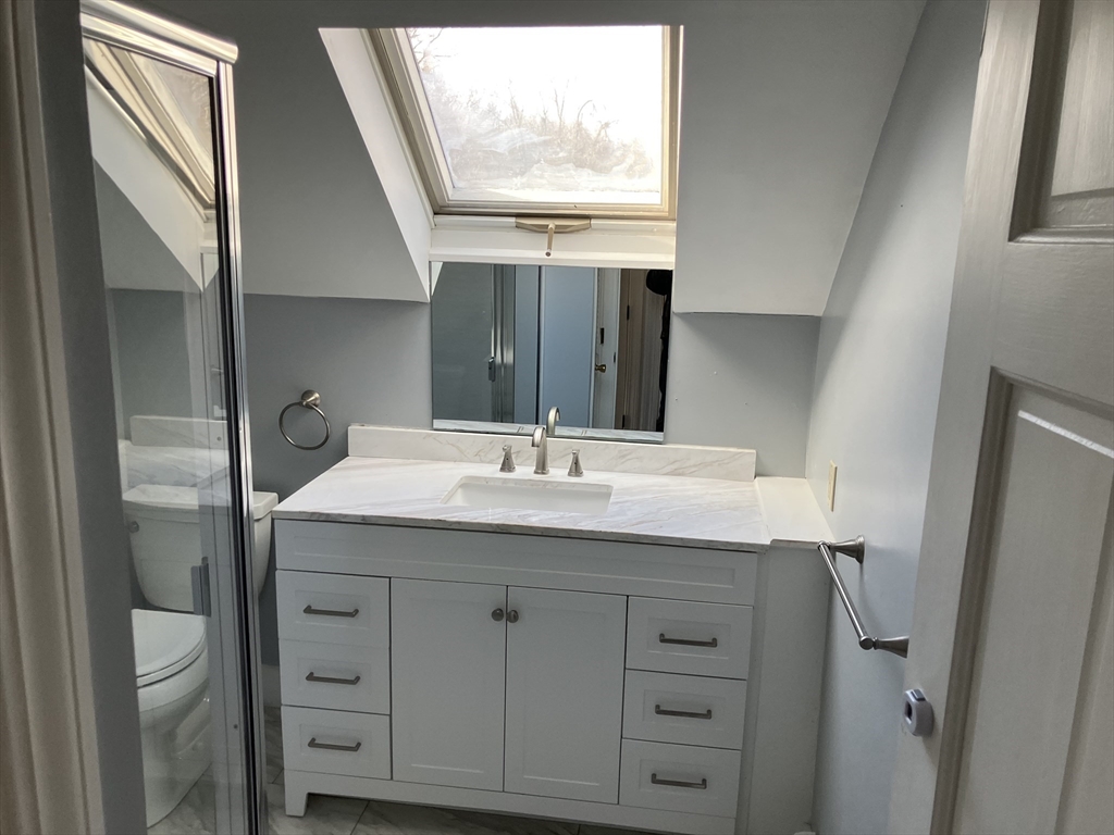 975 South Main Street, Unit 2 Attleboro, MA 02703 - Photo 13 of 17 a bathroom with a granite countertop sink and a mirror