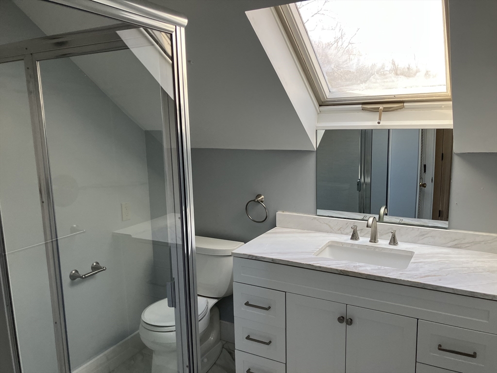 975 South Main Street, Unit 2 Attleboro, MA 02703 - Photo 15 of 17 a bathroom with a granite countertop sink toilet and shower