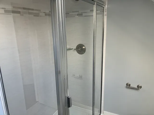 a bathroom with a glass shower door