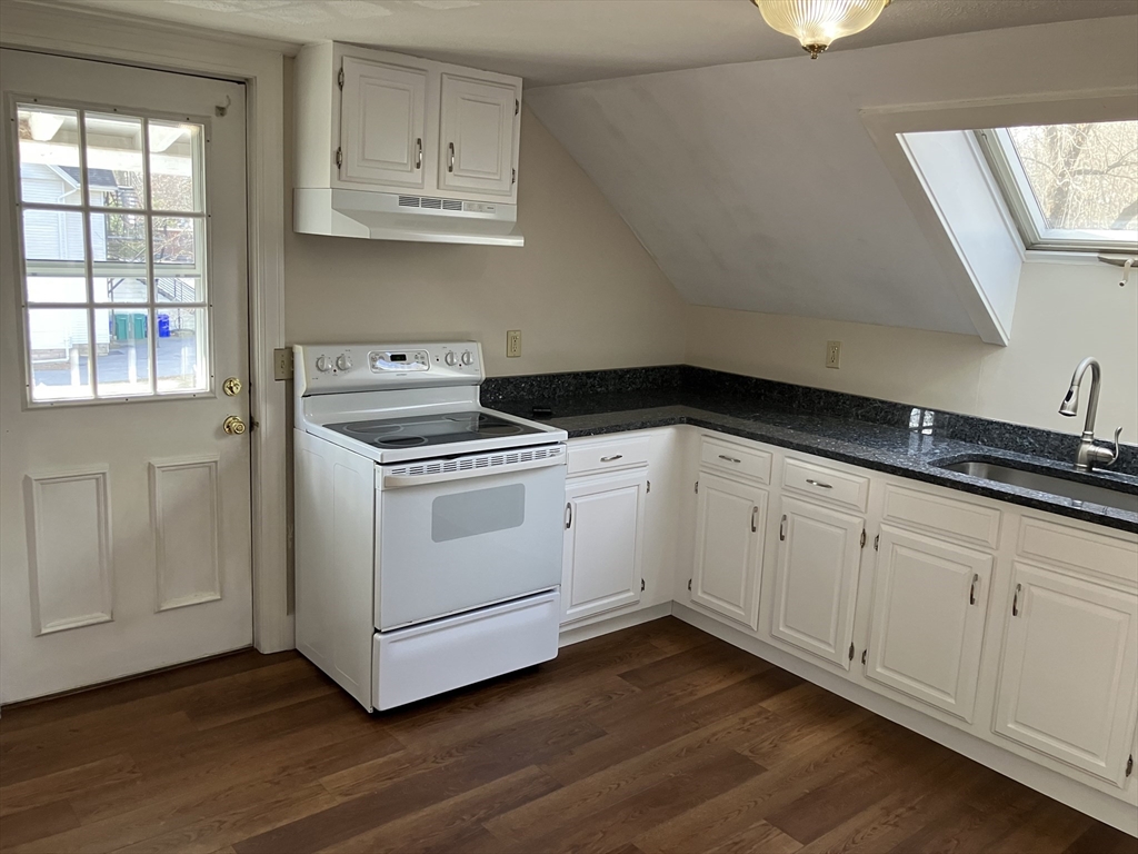 975 South Main Street, Unit 2 Attleboro, MA 02703 - Photo 5 of 17 a kitchen with granite countertop white cabinets and white appliances