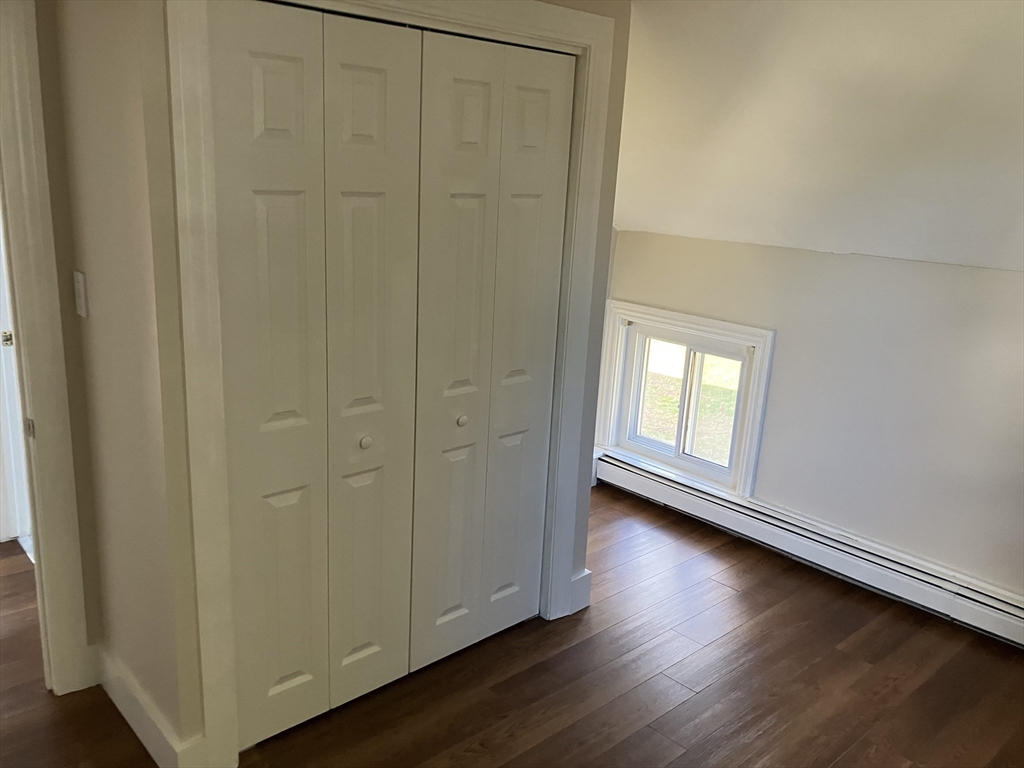 975 South Main Street, Unit 2 Attleboro, MA 02703 - Photo 10 of 17 an empty room with wooden floor and windows
