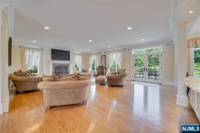 a view of a room with lots of white furniture and a chandelier