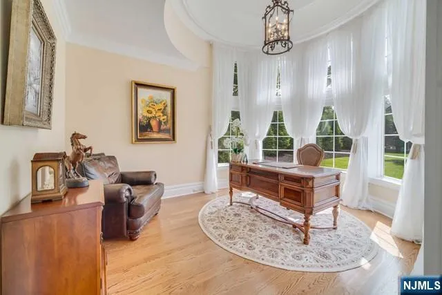 a bedroom with a bed and a dresser next to a window