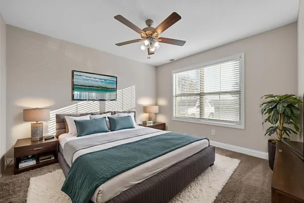 a bedroom with a bed and window