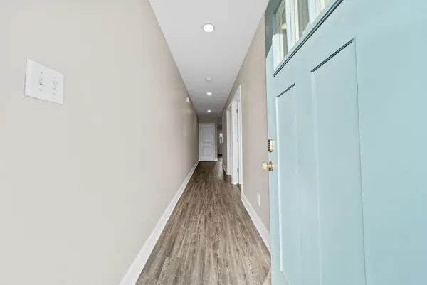 a view of an empty room with a ceiling fan