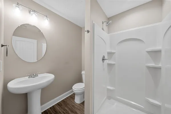 a bathroom with a sink a mirror and a toilet