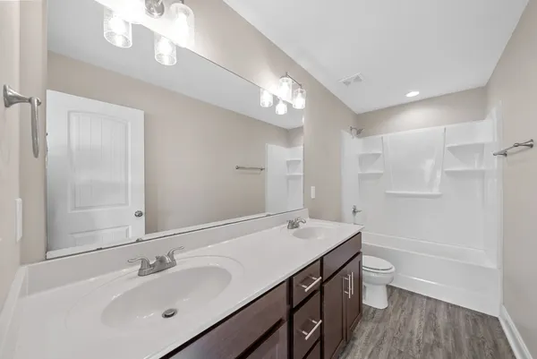 an empty room with closet and windows