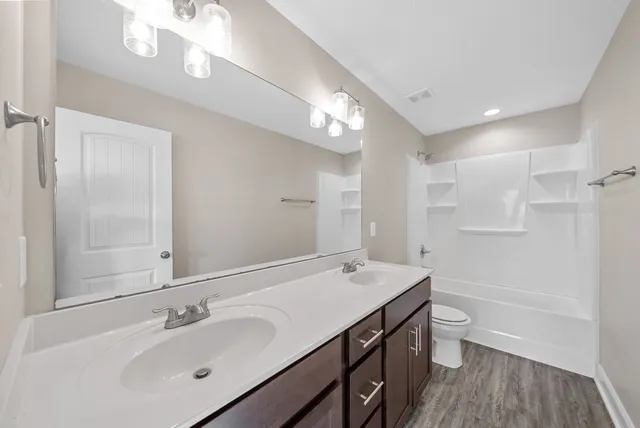 an empty room with closet and windows