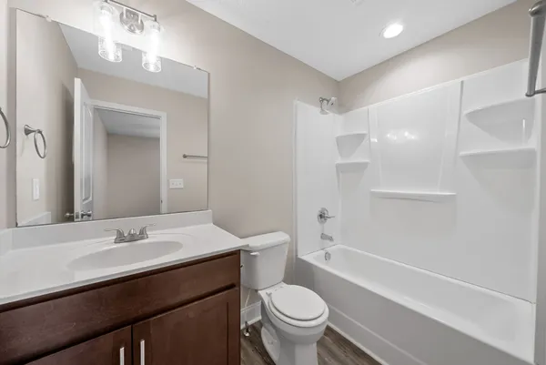 a bathroom with a sink a toilet and mirror