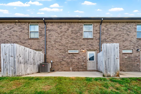 a picture of a bench in front of a wall