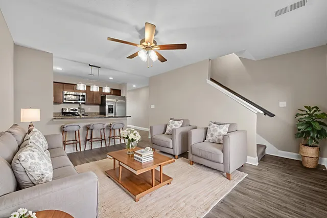 a living room with furniture and a wooden floor