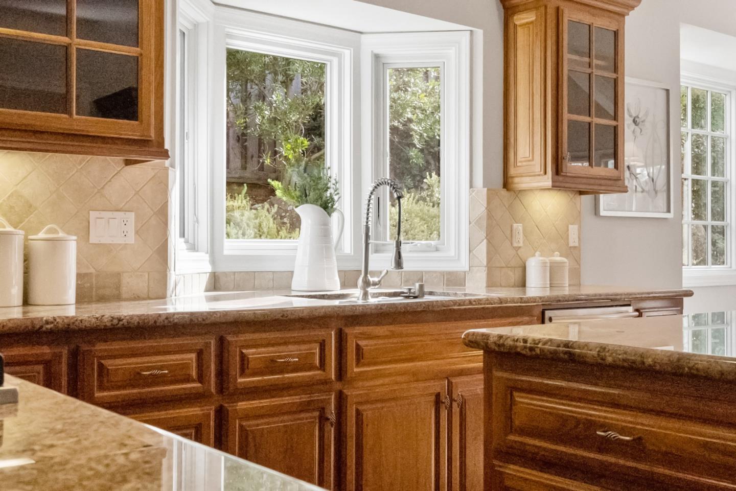 21190 Canyon Oak Way Cupertino, CA 95014 - Photo 12 of 72 a kitchen with stainless steel appliances granite countertop a sink and a stove next to a window