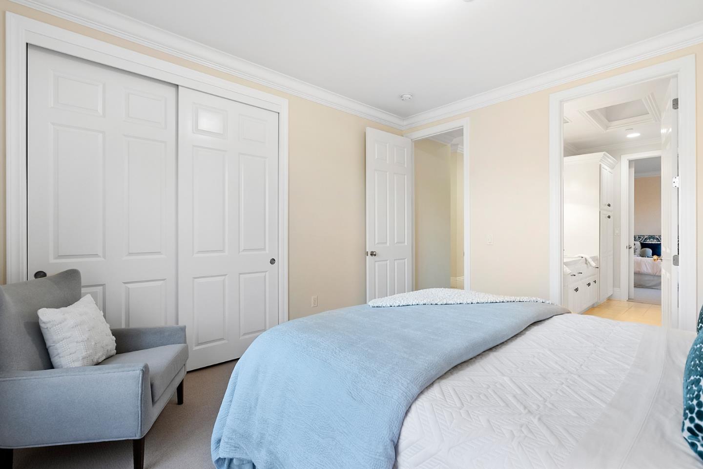 21190 Canyon Oak Way Cupertino, CA 95014 - Photo 38 of 72 a spacious bedroom with a bed and a couch