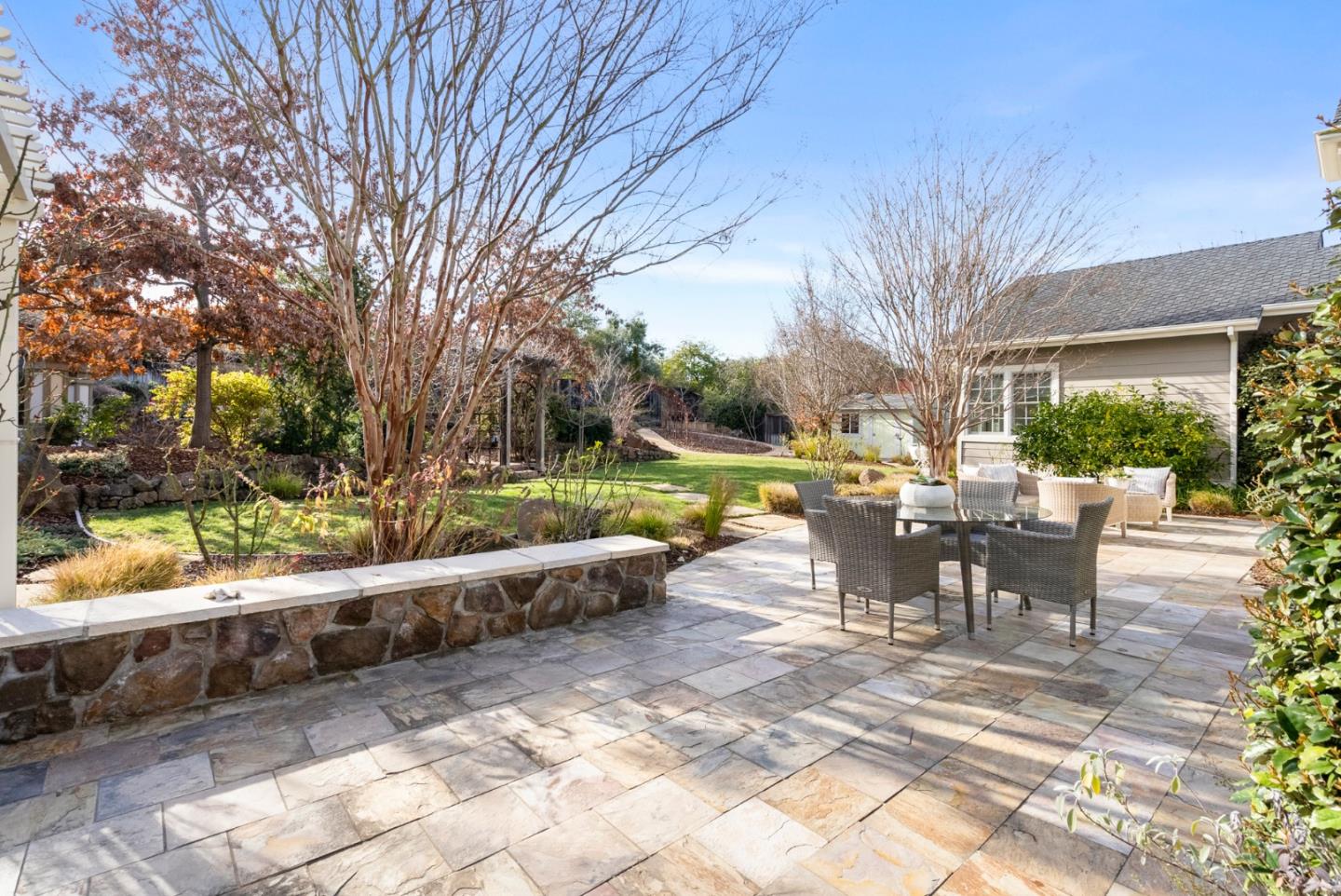 21190 Canyon Oak Way Cupertino, CA 95014 - Photo 48 of 72 a view of a patio with table and chairs and floor to ceiling window