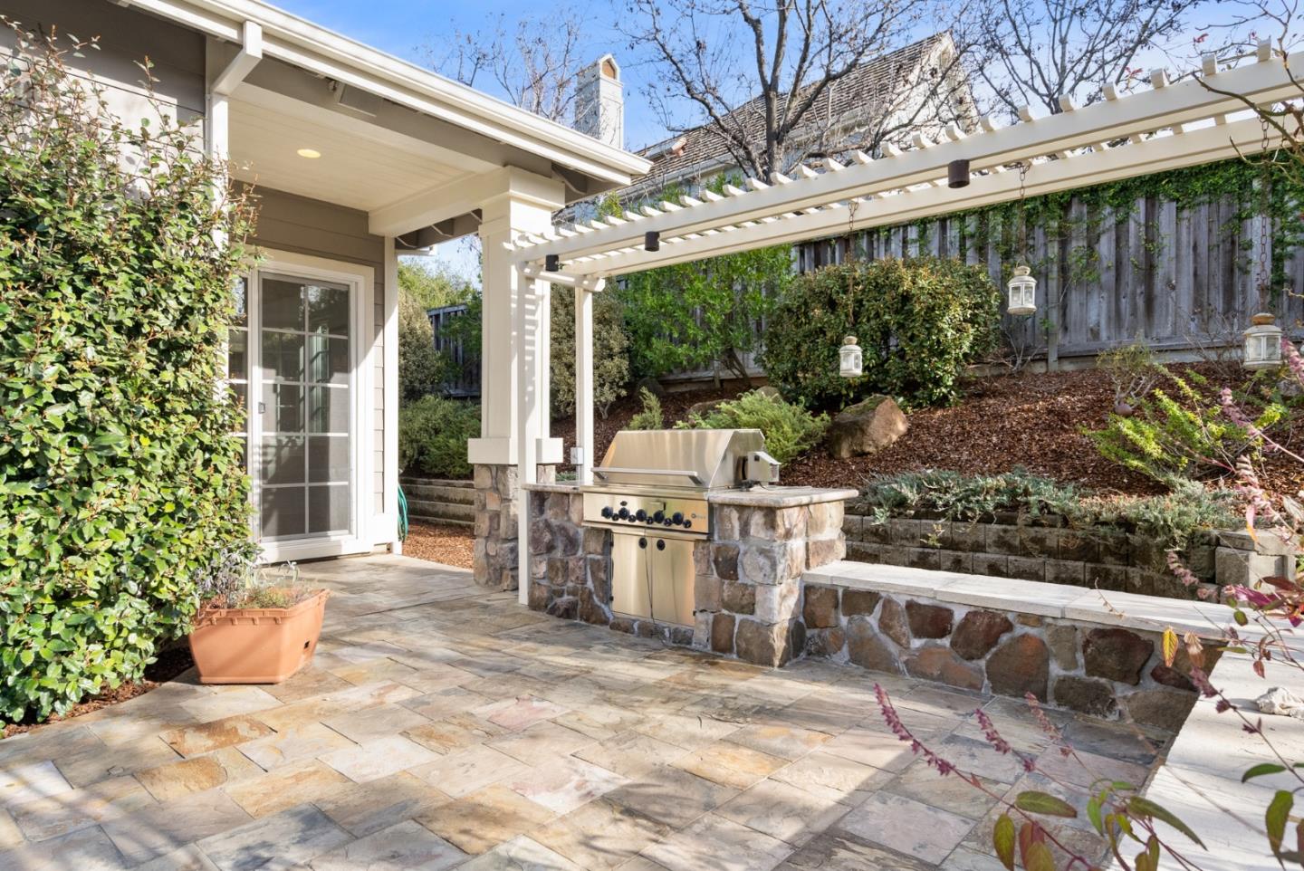 21190 Canyon Oak Way Cupertino, CA 95014 - Photo 49 of 72 a view of a chairs and table in backyard of the house