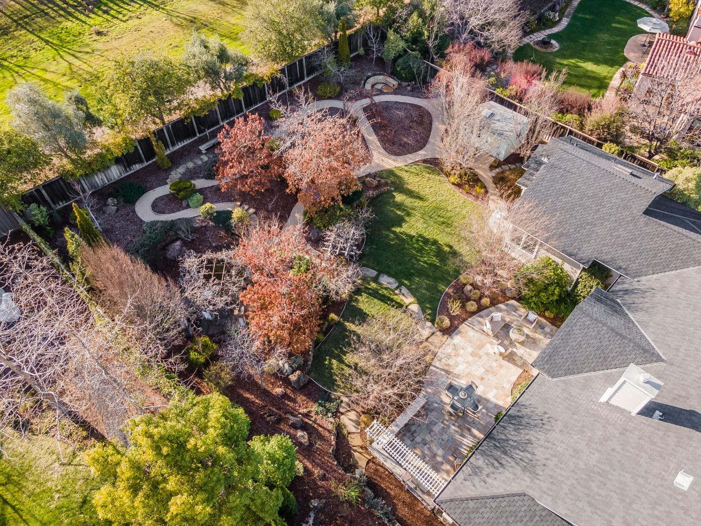 21190 Canyon Oak Way Cupertino, CA 95014 - Photo 67 of 72 a view of a backyard with chairs and a fire pit