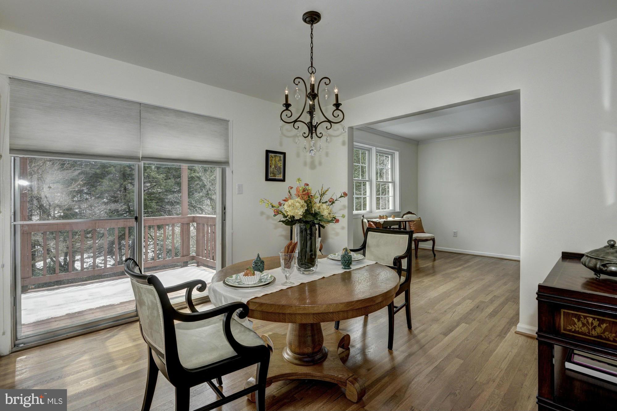 14117 Sturtevant Road Silver Spring, MD 20905 - Photo 11 of 30 a dining room with furniture a chandelier and wooden floor