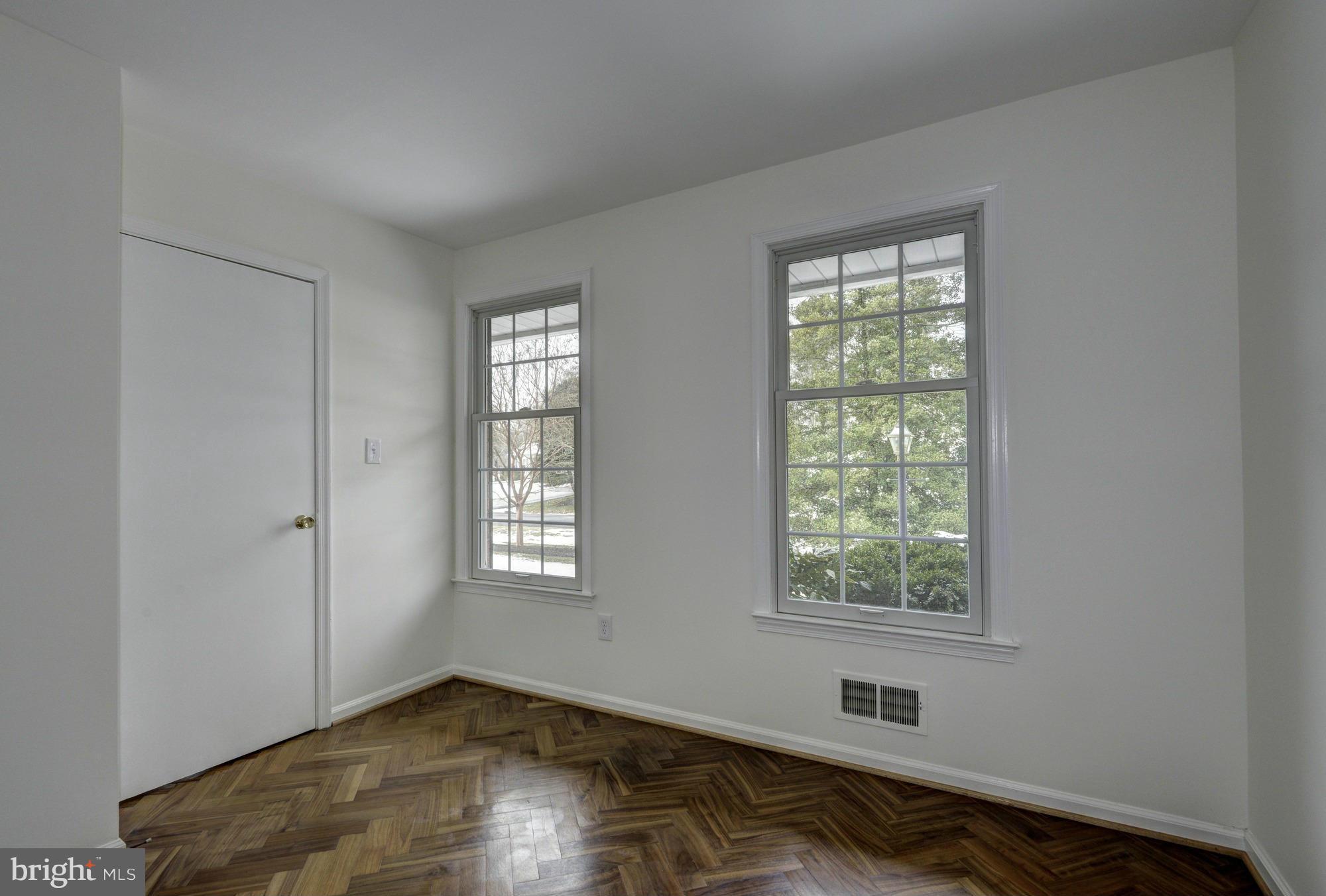 14117 Sturtevant Road Silver Spring, MD 20905 - Photo 12 of 30 a view of an empty room with wooden floor and a window