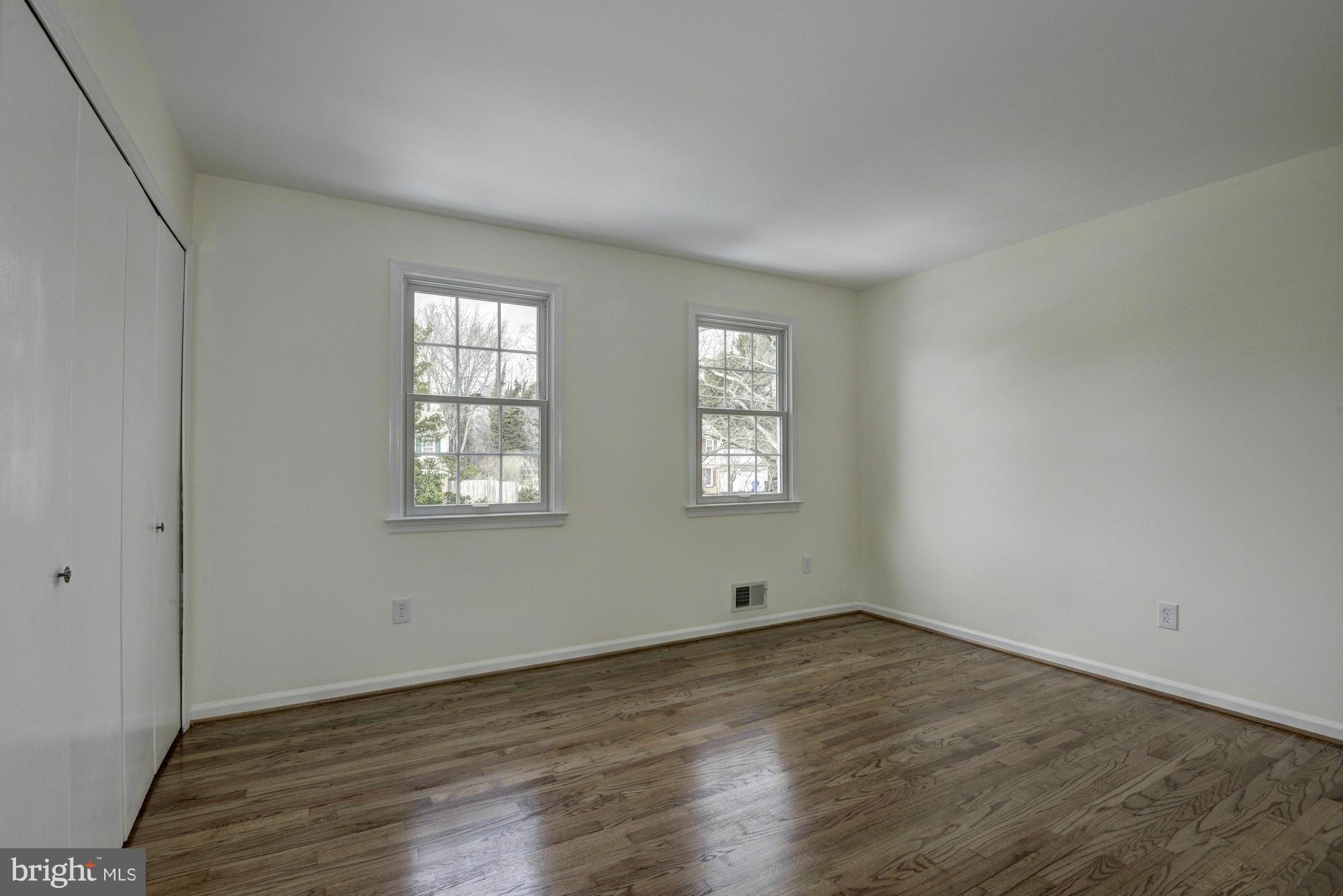 14117 Sturtevant Road Silver Spring, MD 20905 - Photo 17 of 30 an empty room with wooden floor and windows