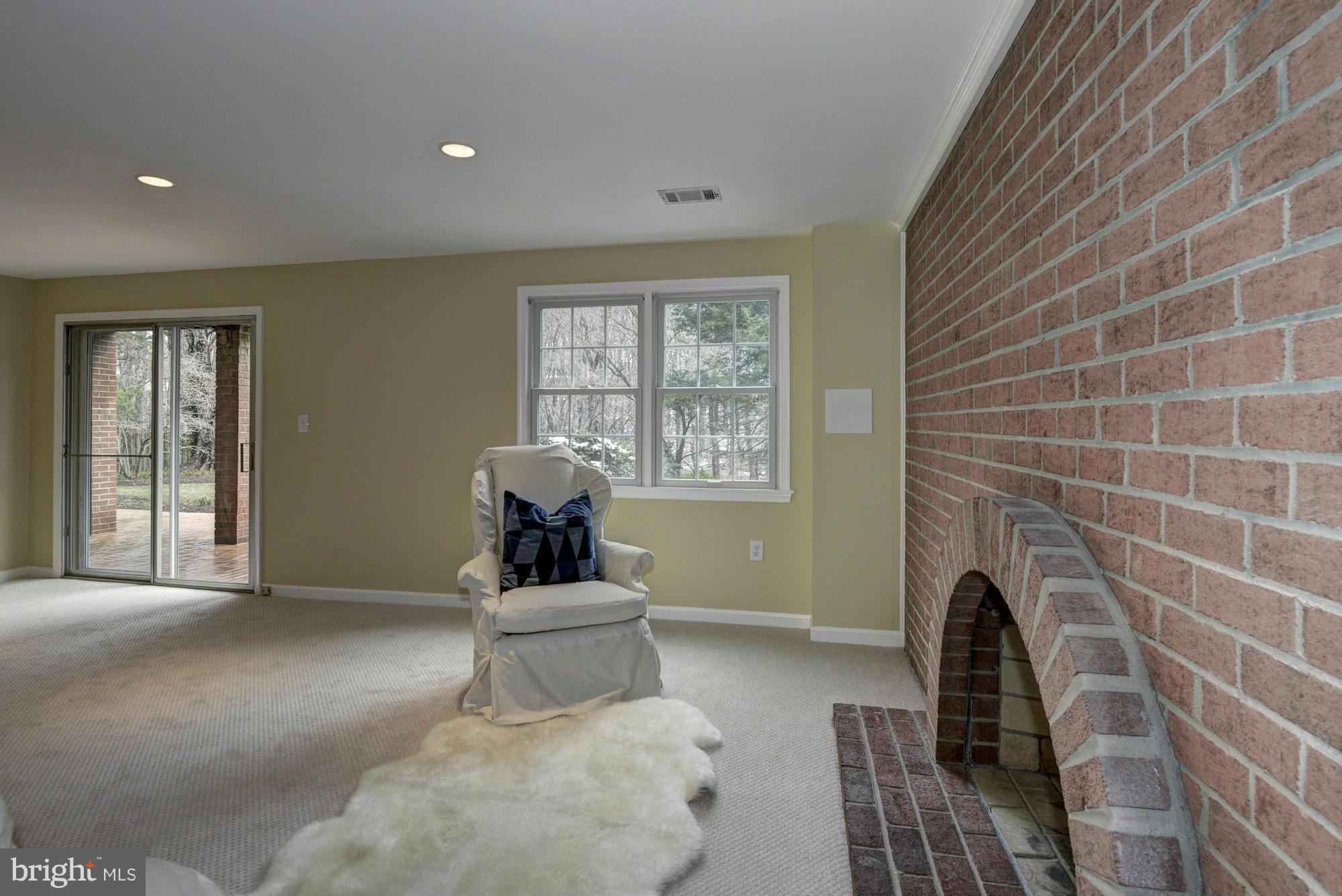 14117 Sturtevant Road Silver Spring, MD 20905 - Photo 20 of 30 a living room with furniture a window and a fireplace
