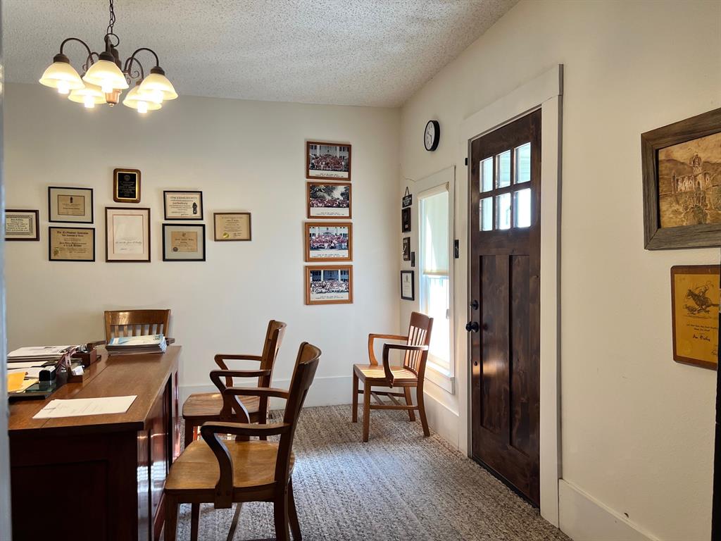306 North Austin Street Comanche, TX 76442 - Photo 19 of 37 a view of a dining room with furniture and chandelier