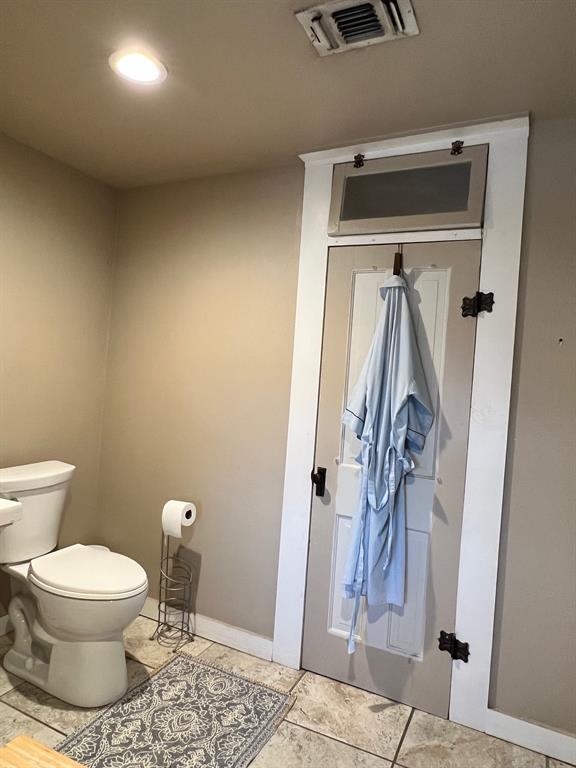 306 North Austin Street Comanche, TX 76442 - Photo 31 of 37 a bathroom with a toilet and a shower