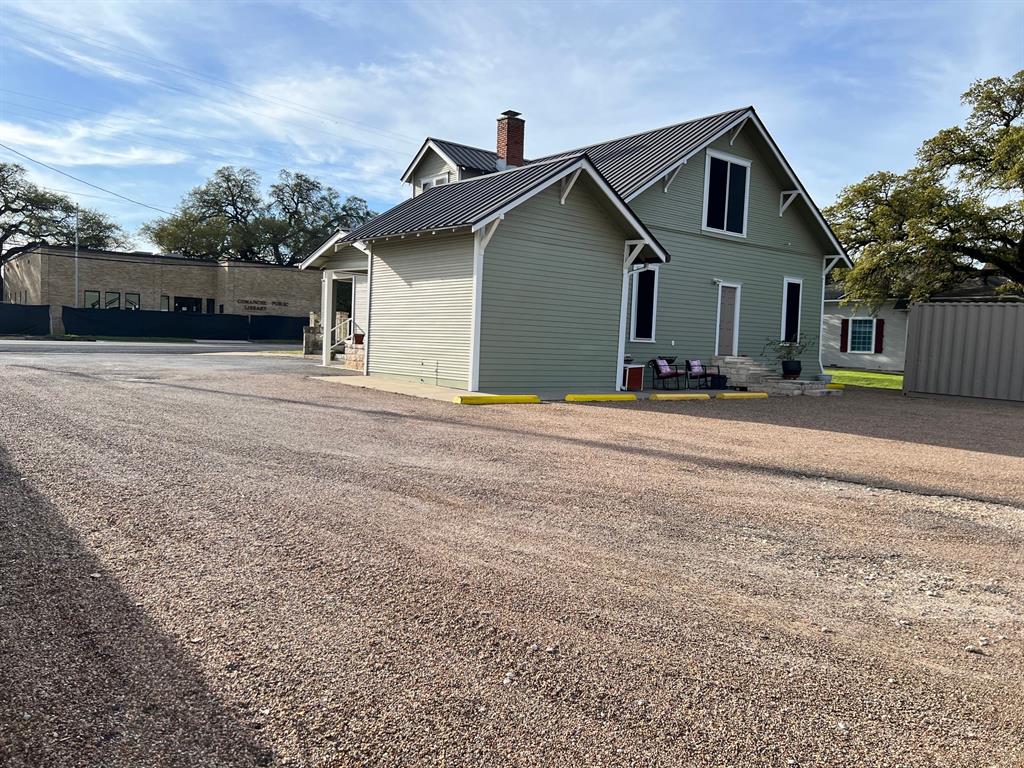 306 North Austin Street Comanche, TX 76442 - Photo 35 of 37 a front view of a house with a yard and garage