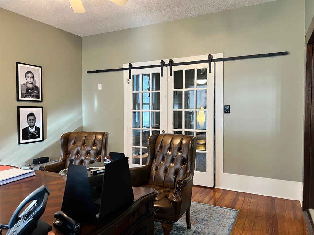 306 North Austin Street Comanche, TX 76442 - Photo 10 of 37 a view of a workspace with furniture and wooden floor