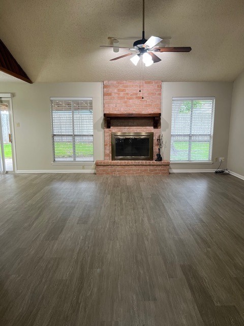 5122 Goldeneye Drive Corpus Christi, TX 78413 - Photo 2 of 14 an empty room with wooden floor fireplace cabinet and windows