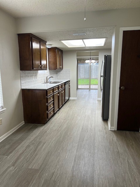 5122 Goldeneye Drive Corpus Christi, TX 78413 - Photo 5 of 14 a kitchen with stainless steel appliances granite countertop a refrigerator a sink dishwasher a stove and a wooden floor