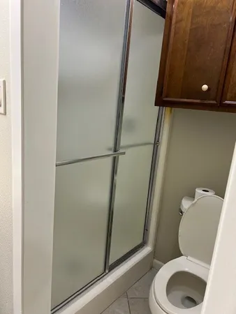 a bathroom with a toilet and a shower
