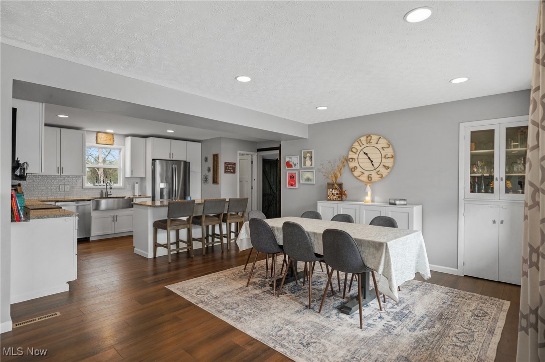 87 Kenridge Road Akron, OH 44333 - Photo 11 of 48 Dining room featuring a textured ceiling, visible vents, dark wood-style flooring, and recessed lighting