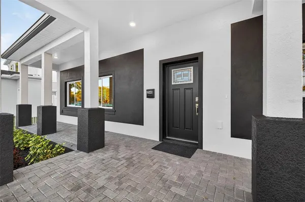 a view of a hallway with wooden floor and seating space