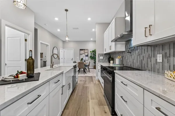 a kitchen with stainless steel appliances granite countertop sink stove top oven and cabinets