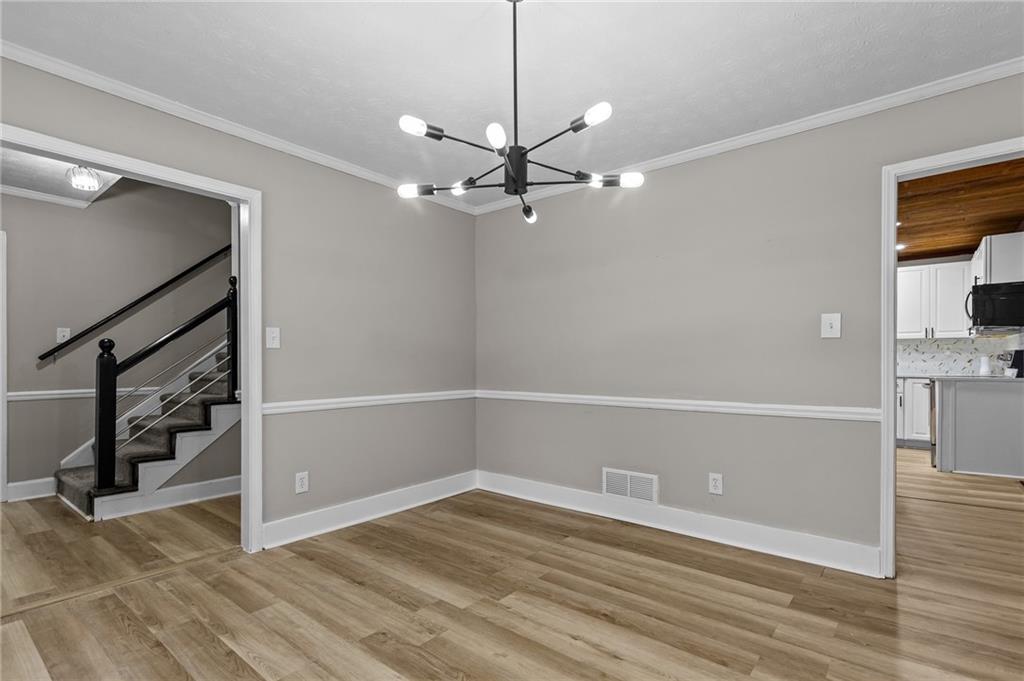 800 Post Rd Circle Stone Mountain, GA 30088 - Photo 11 of 45 wooden floor in an empty room with a window