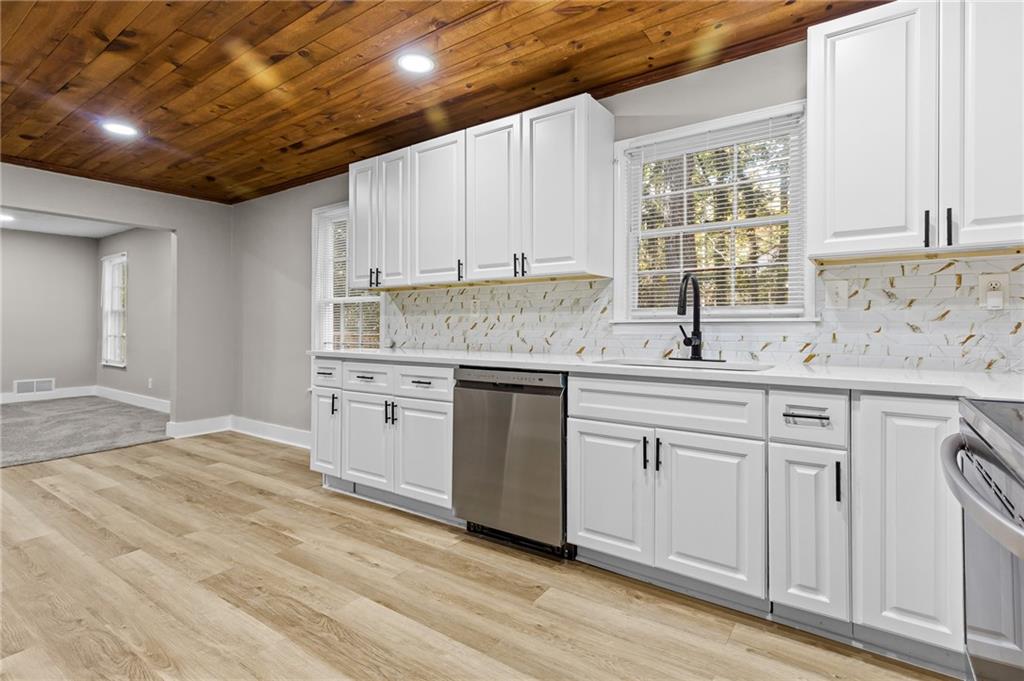 800 Post Rd Circle Stone Mountain, GA 30088 - Photo 12 of 45 a kitchen with granite countertop white cabinets and white appliances