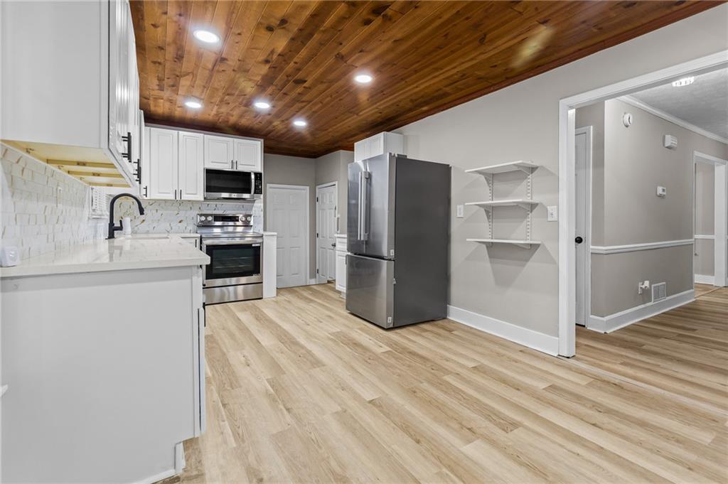 800 Post Rd Circle Stone Mountain, GA 30088 - Photo 18 of 45 a kitchen with stainless steel appliances a refrigerator and a stove top oven
