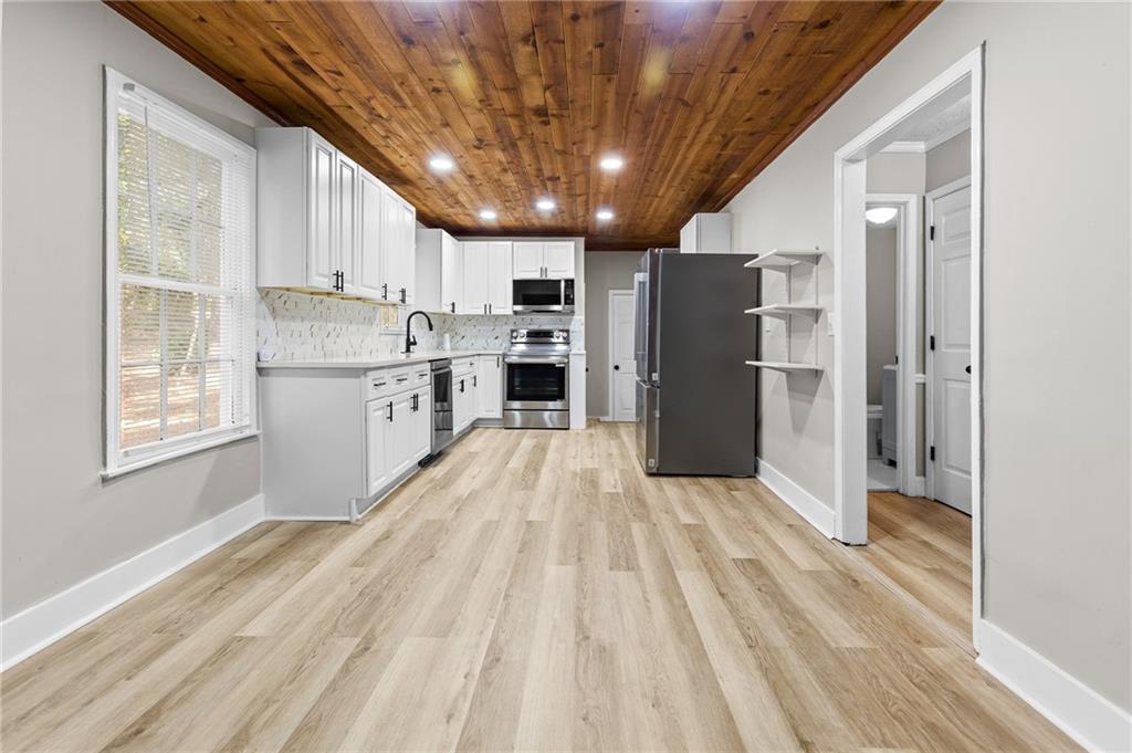 800 Post Rd Circle Stone Mountain, GA 30088 - Photo 20 of 45 a view of kitchen with stainless steel appliances granite countertop a refrigerator a sink dishwasher and a stove with wooden floor