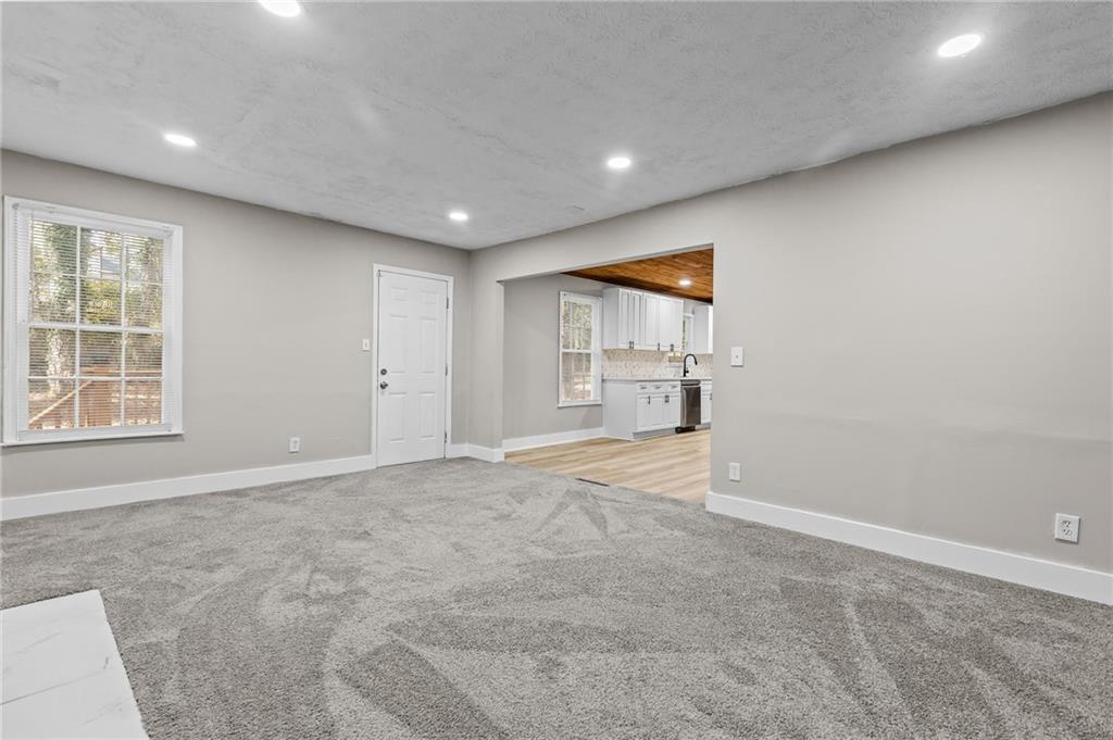 800 Post Rd Circle Stone Mountain, GA 30088 - Photo 23 of 45 an empty room with windows and pillars in it