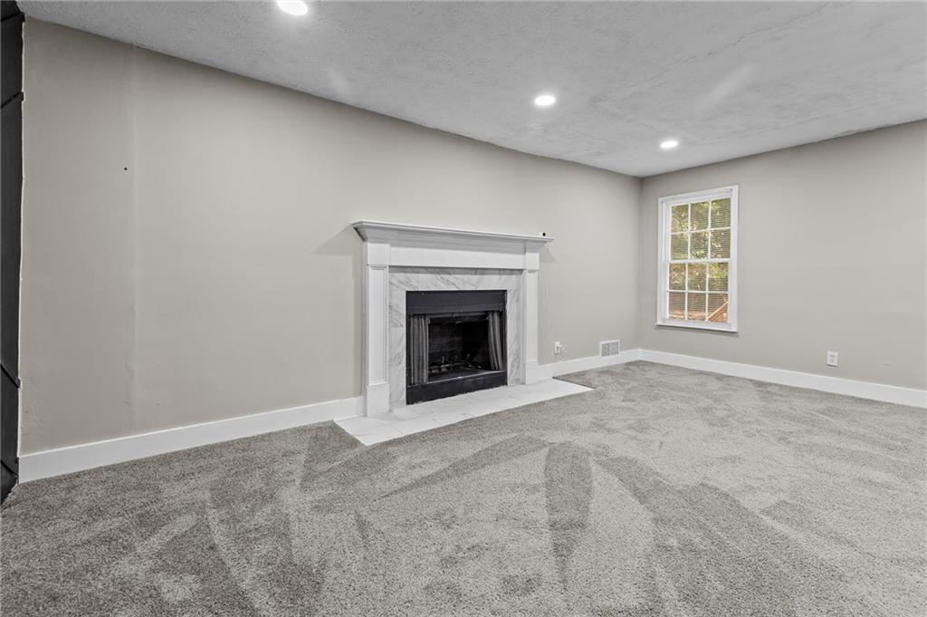 800 Post Rd Circle Stone Mountain, GA 30088 - Photo 24 of 45 an empty room with a fireplace and a window