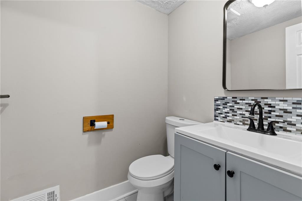 800 Post Rd Circle Stone Mountain, GA 30088 - Photo 25 of 45 a bathroom with a sink a toilet and a mirror