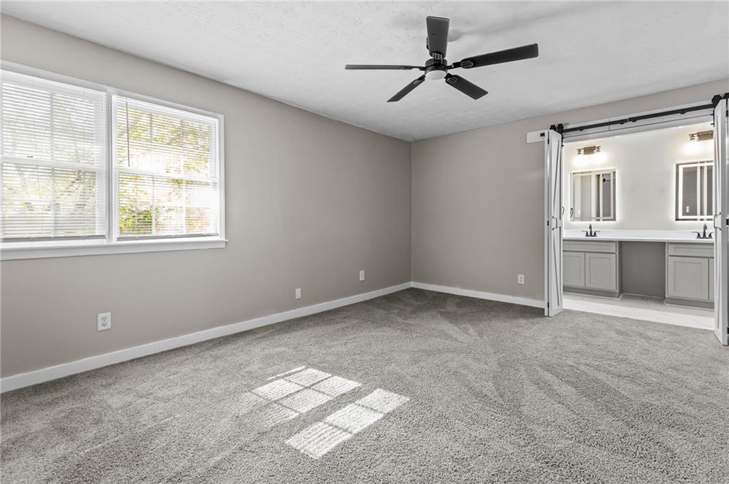 800 Post Rd Circle Stone Mountain, GA 30088 - Photo 28 of 45 a view of a big room with windows and chandelier fan